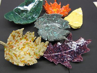 clay leaves painted in blue, green, orange, purple and yellow