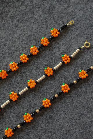 photo of three beaded bracelets featuring orange pumpkins and black spacer beads