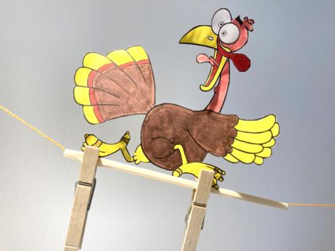 colored paper turkey looking to be ziplining away from something 