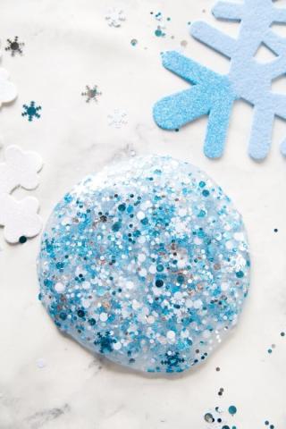 pile of glittery blue and silver slime with snowflake sparkles included.