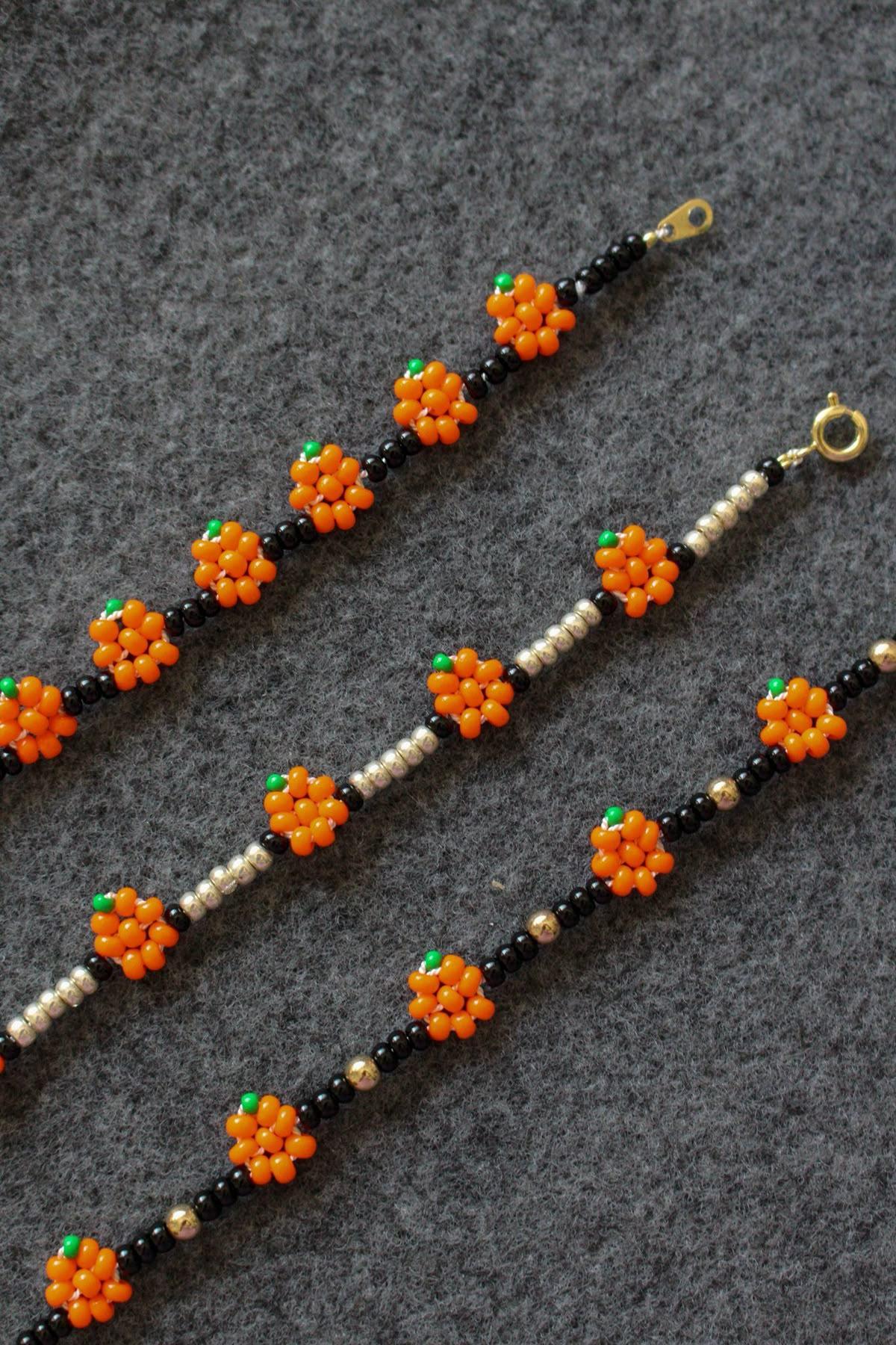 photo of three beaded bracelets featuring orange pumpkins and black spacer beads