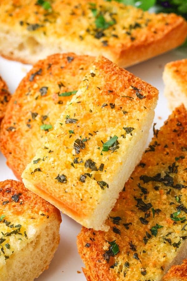 slices of garlic bread sprinkled with parsley